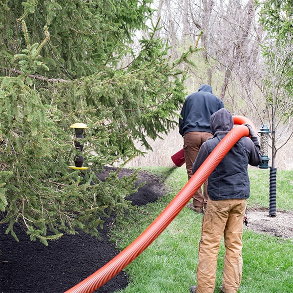 mulch blowing involves using a specialized machine to evenly distribute mulch on a designated area